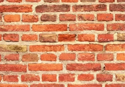 A brick wall with some type of substance on it