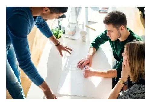 A group of people sitting around a table.